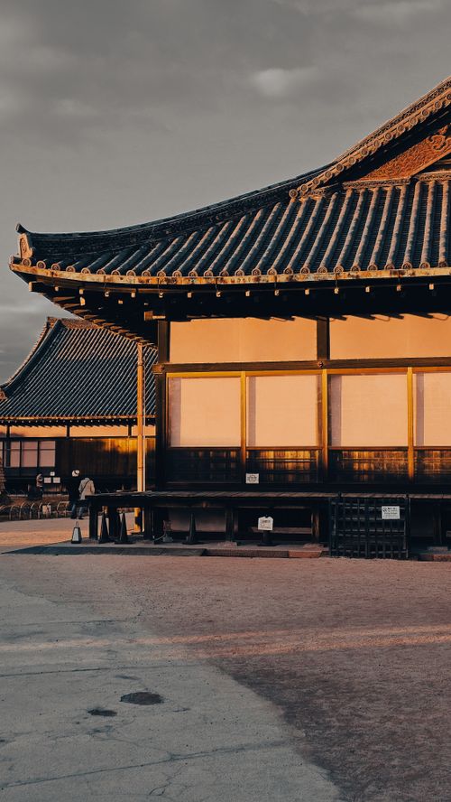 Free Serene view of traditional Korean architecture bathed in warm sunset light. Stock Photo