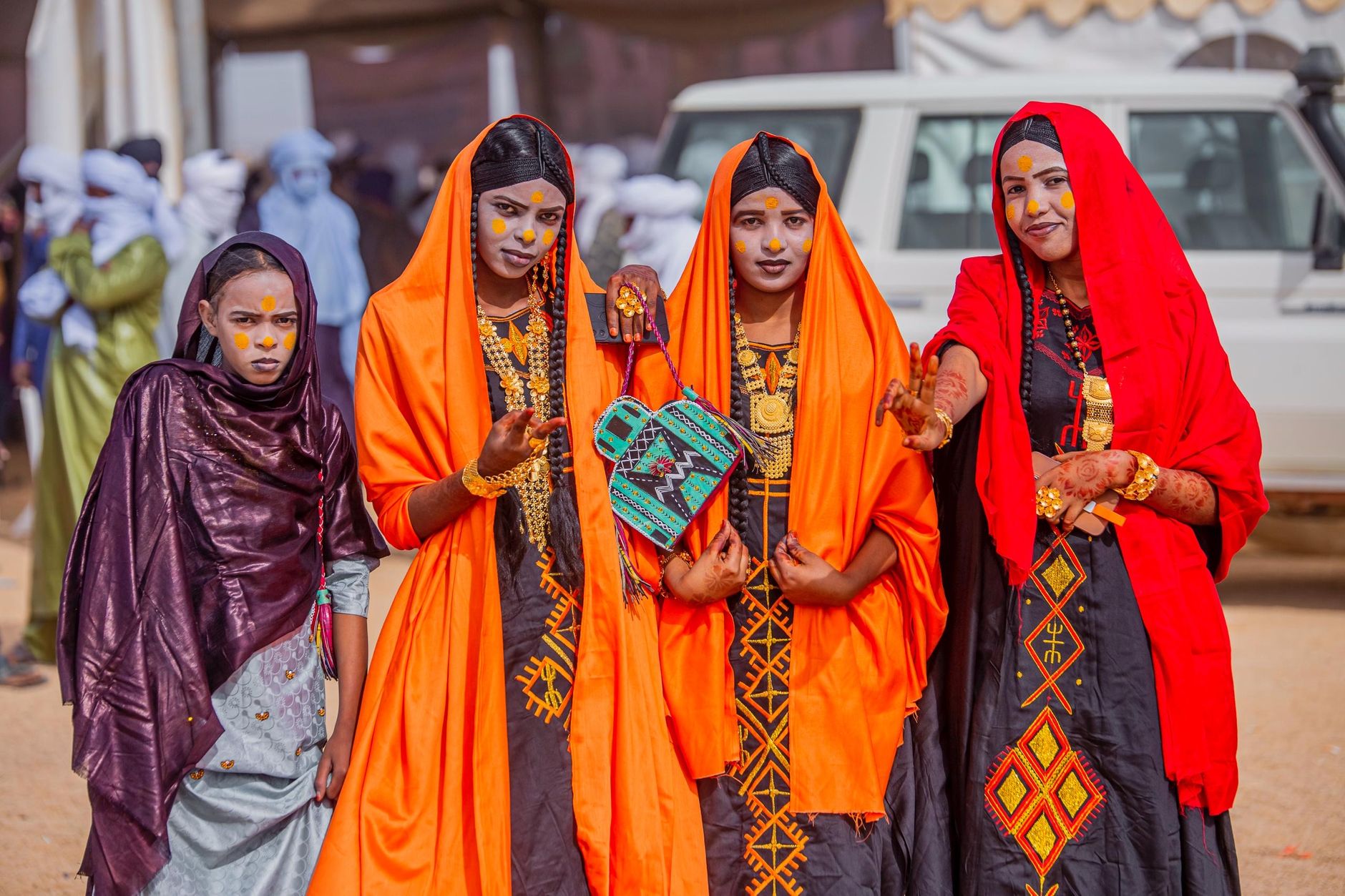 Vibrant display of Tuareg fashion with women in traditional attire, showcasing cultural heritage.