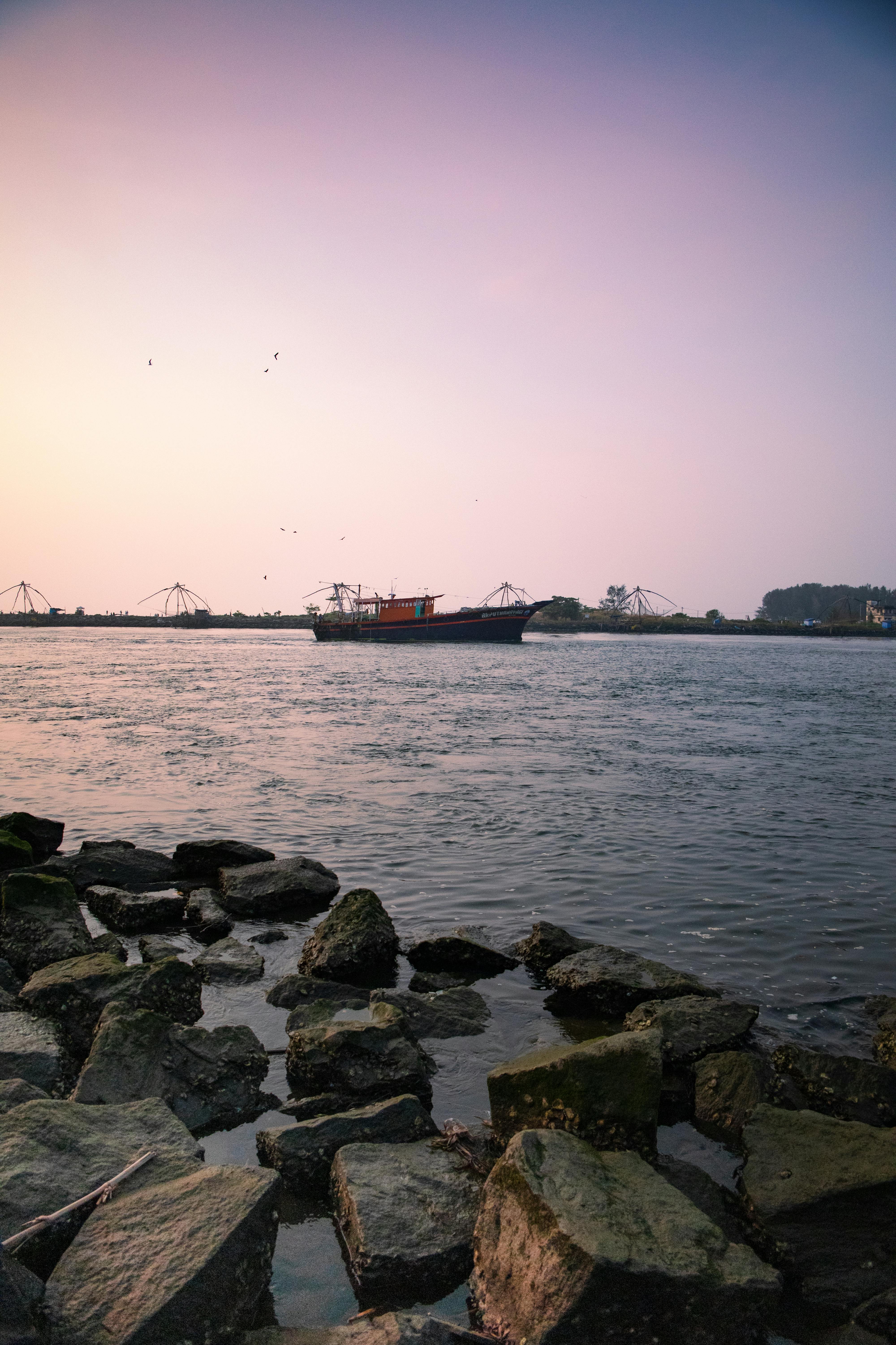 Free stock photo of a sunset in the field, above sea, fishing boat