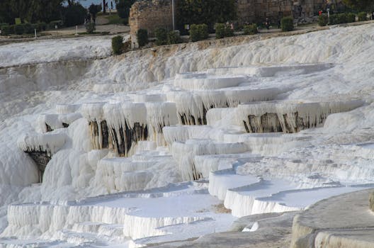 Explore the breathtaking white travertine terraces at Pamukkale in Turkey, a UNESCO World Heritage Site.