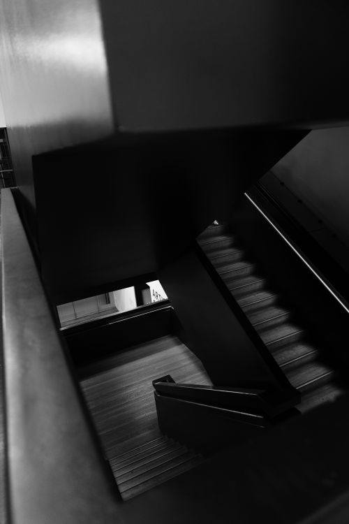 Free A dramatic black and white view of a geometric staircase with strong contrasts. Stock Photo
