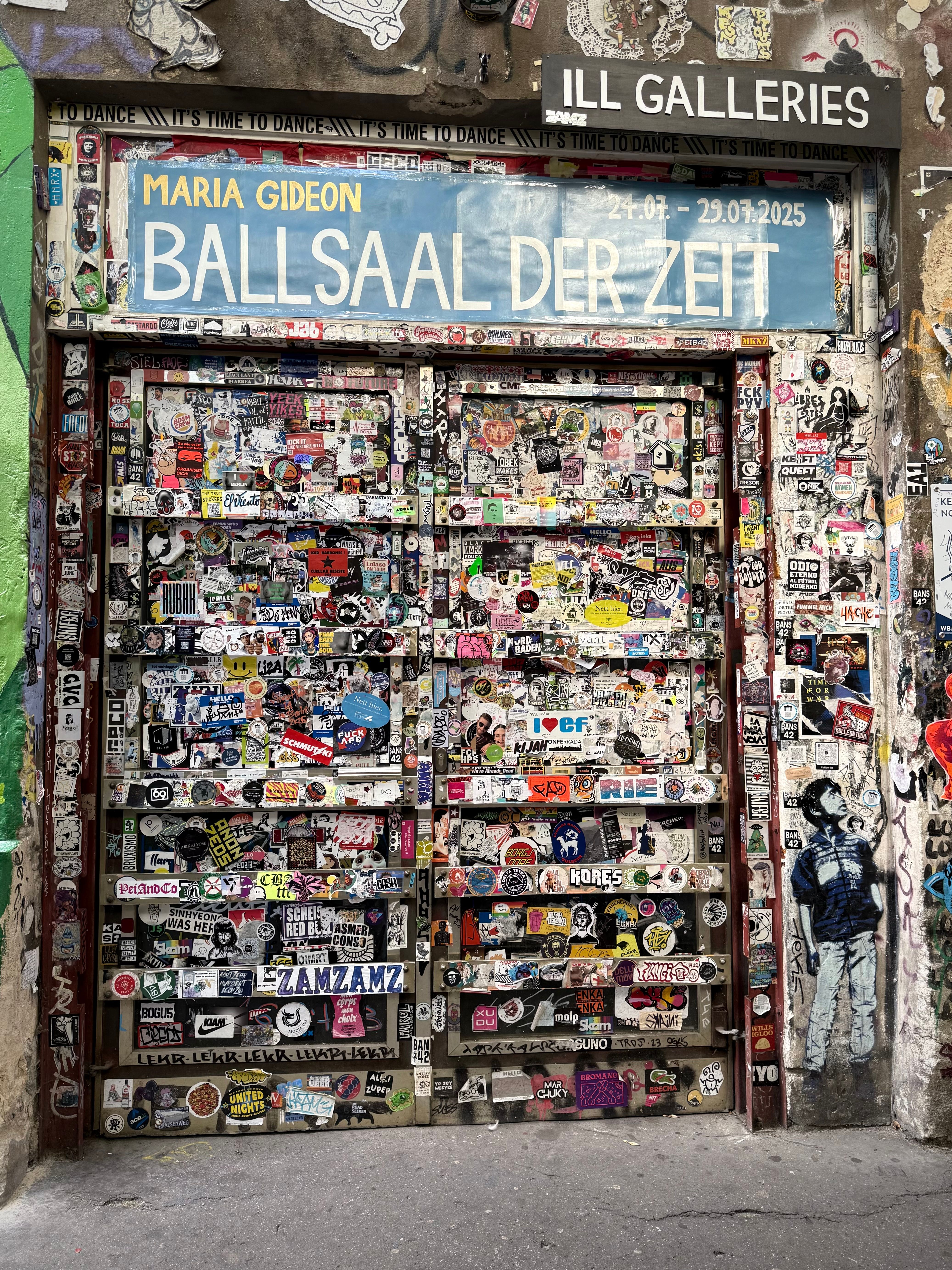 A vibrant display of stickers on a door in Berlin, capturing the city's urban street art vibe.