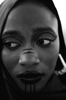 Stunning black and white portrait capturing expressive makeup and emotion.