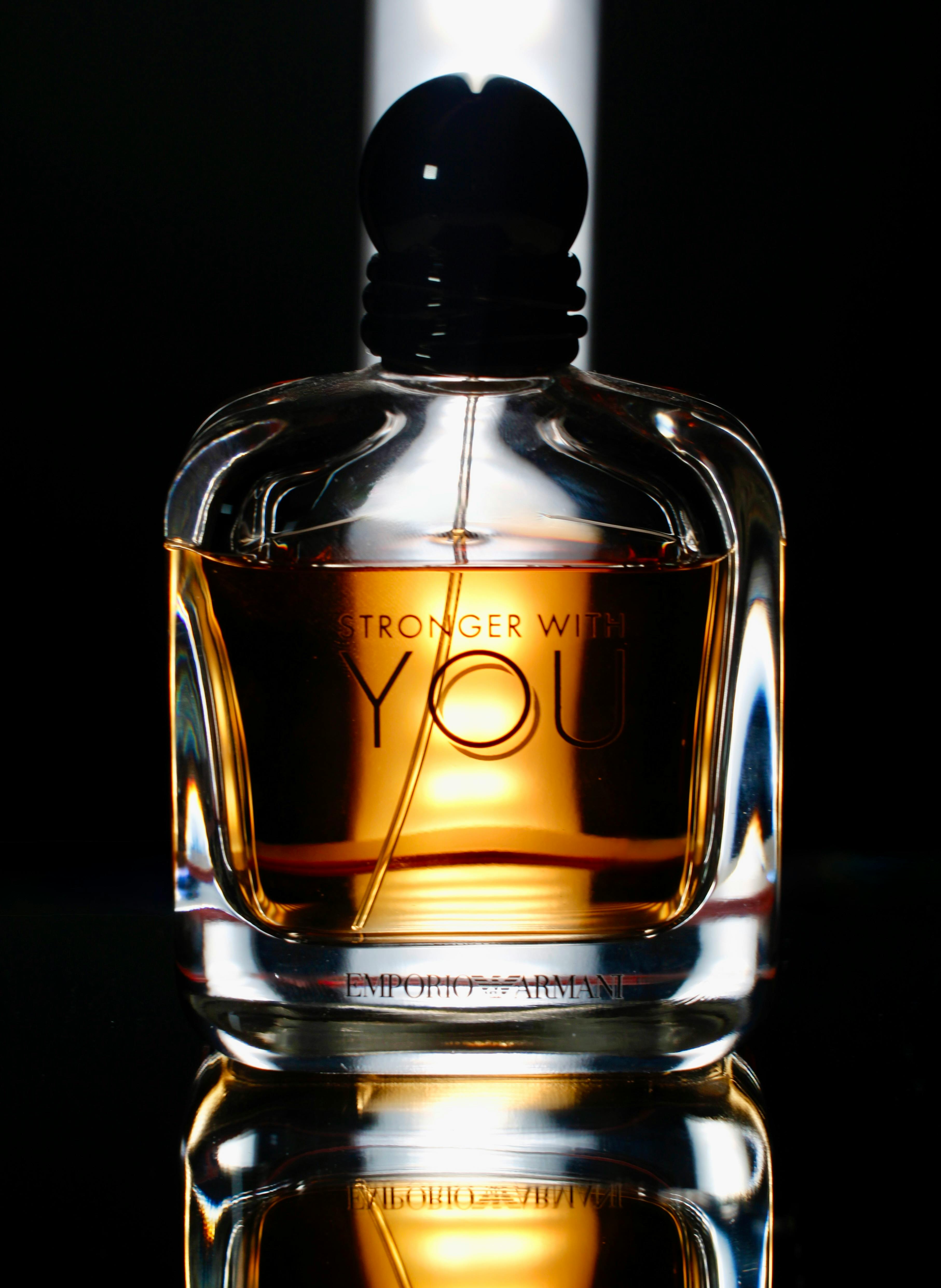 Stylish cologne bottle captured with dramatic lighting, showcasing elegance.