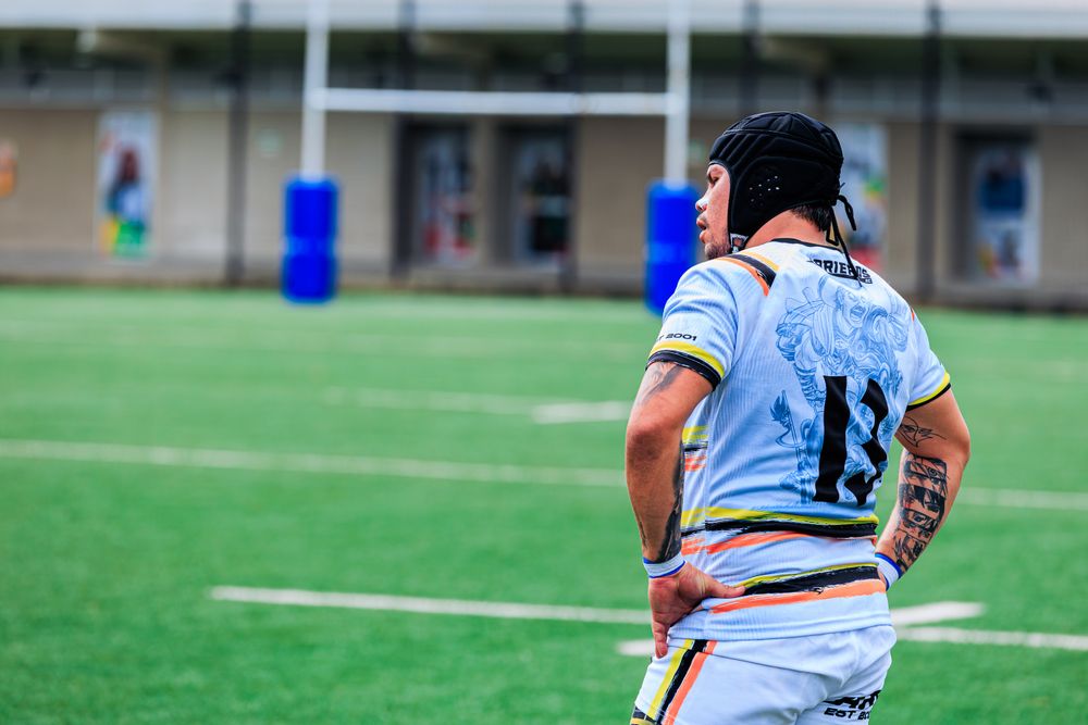 Rugby player wearing a team jersey on an outdoor field