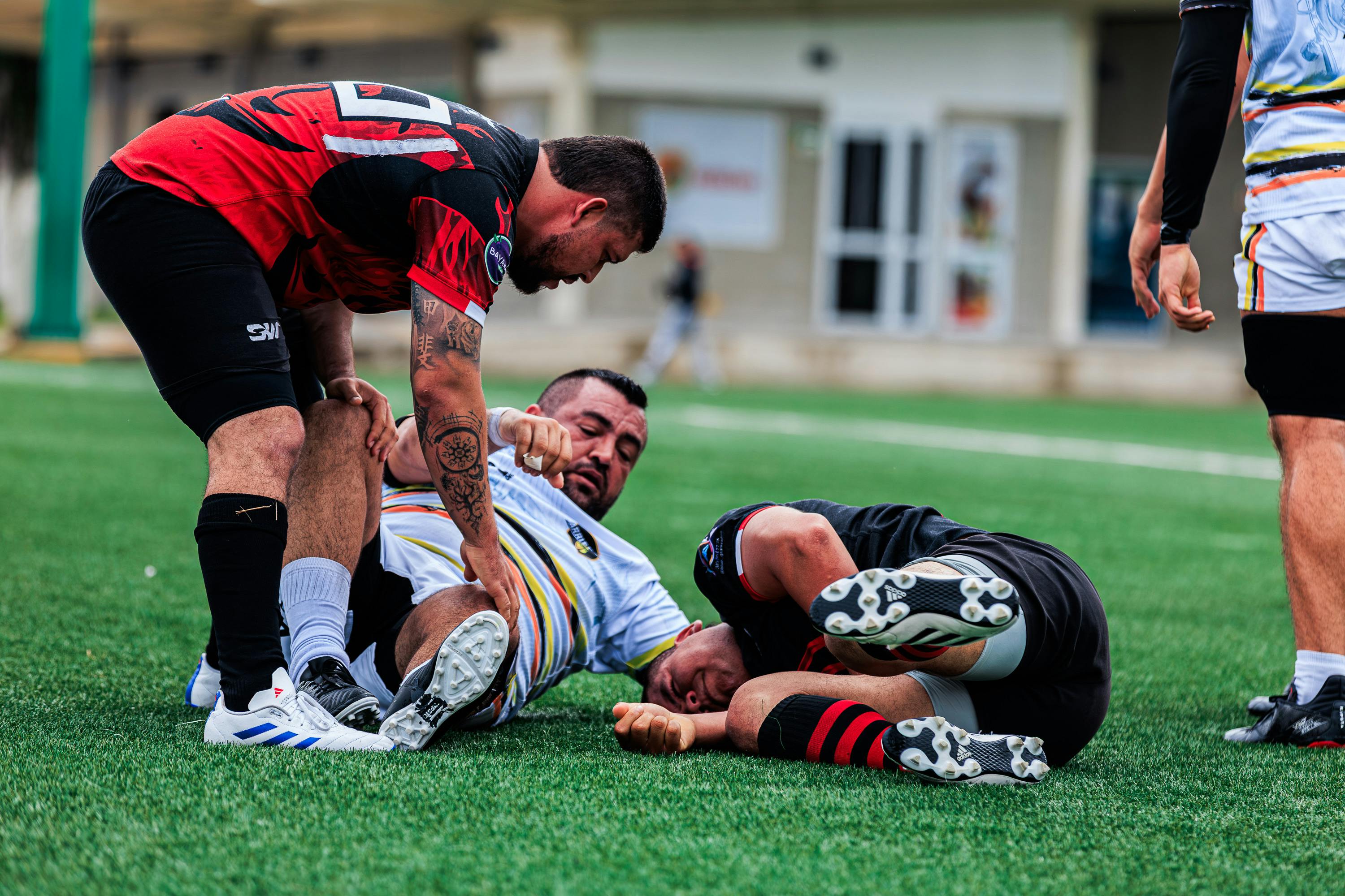 Rugby players clash on a vibrant field, showing teamwork and competition in action.