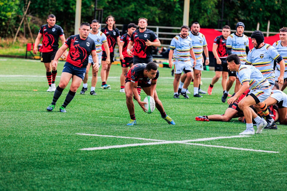 How Whoop Recovery Score Prevents Overtraining for CrossFit Athletes Players in action during a competitive rugby match on a green field.