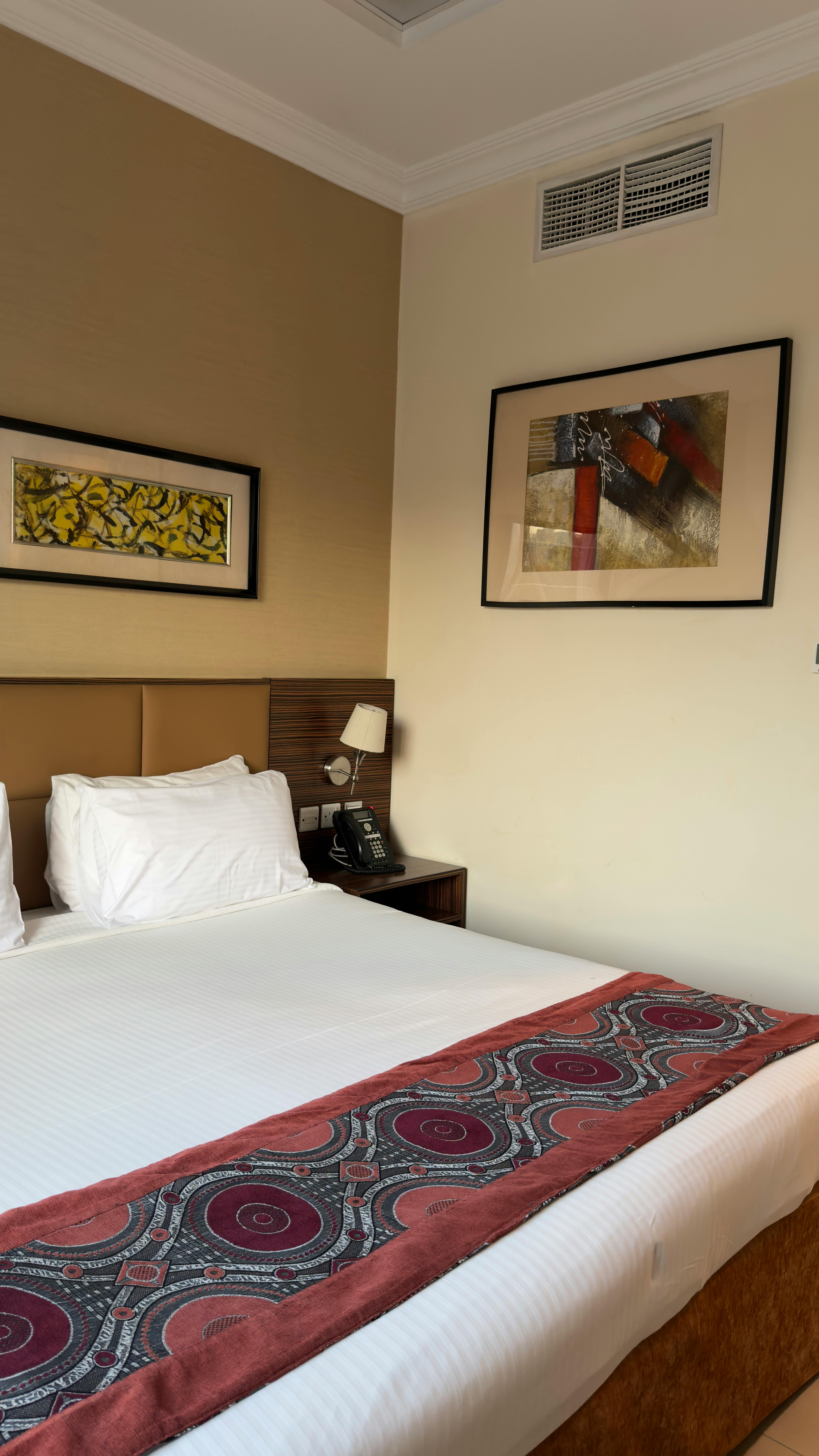 Inviting modern hotel room with stylish decor and comfortable bedding.
