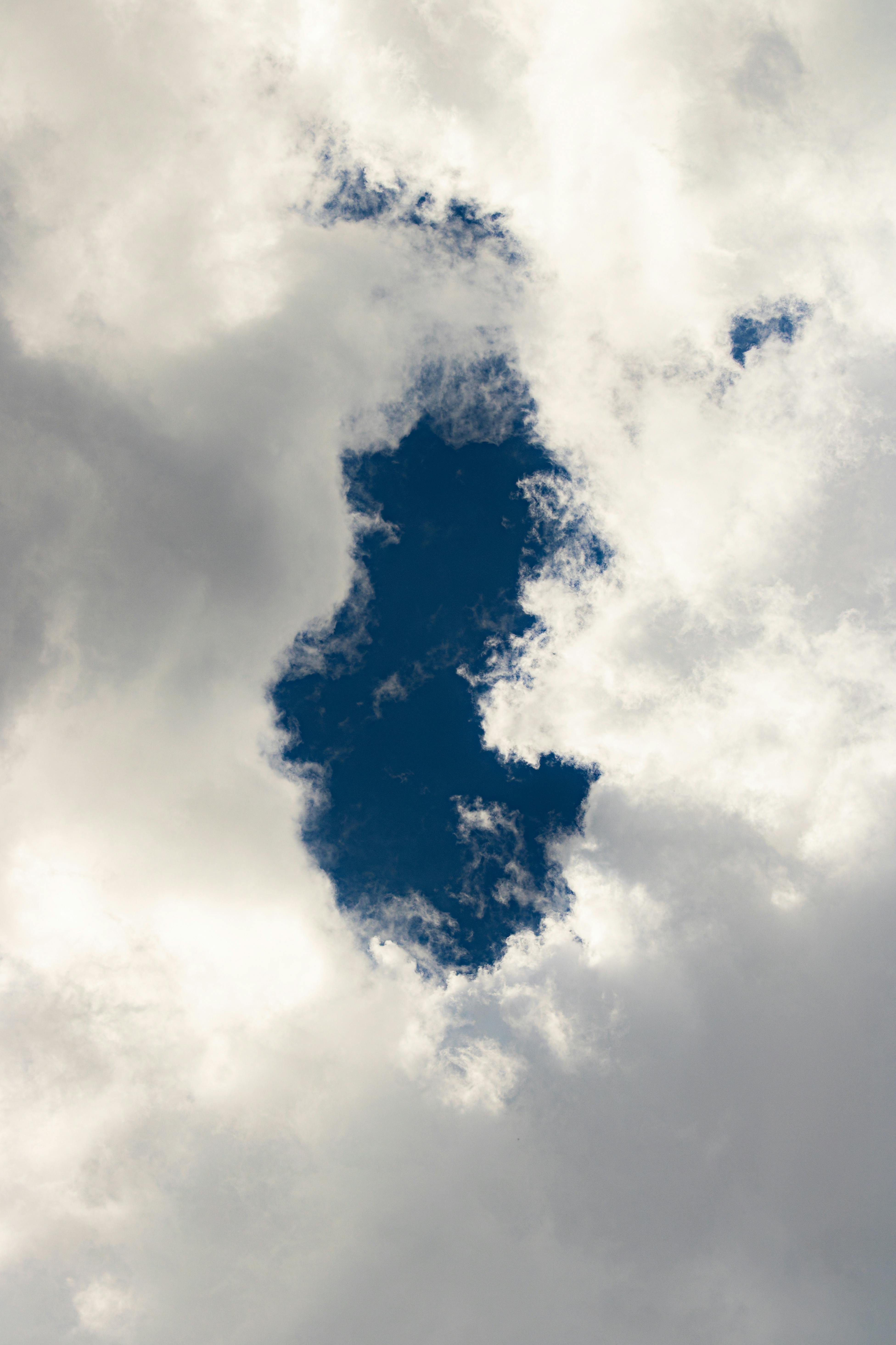 Capture of a dramatic cloudy sky with an opening revealing blue sky.