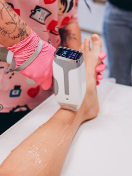 Close-up of a laser hair removal procedure on a client's leg, showcasing modern beauty treatment.