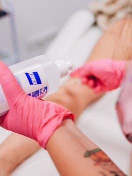 Skincare treatment with lotion application by a professional wearing gloves.