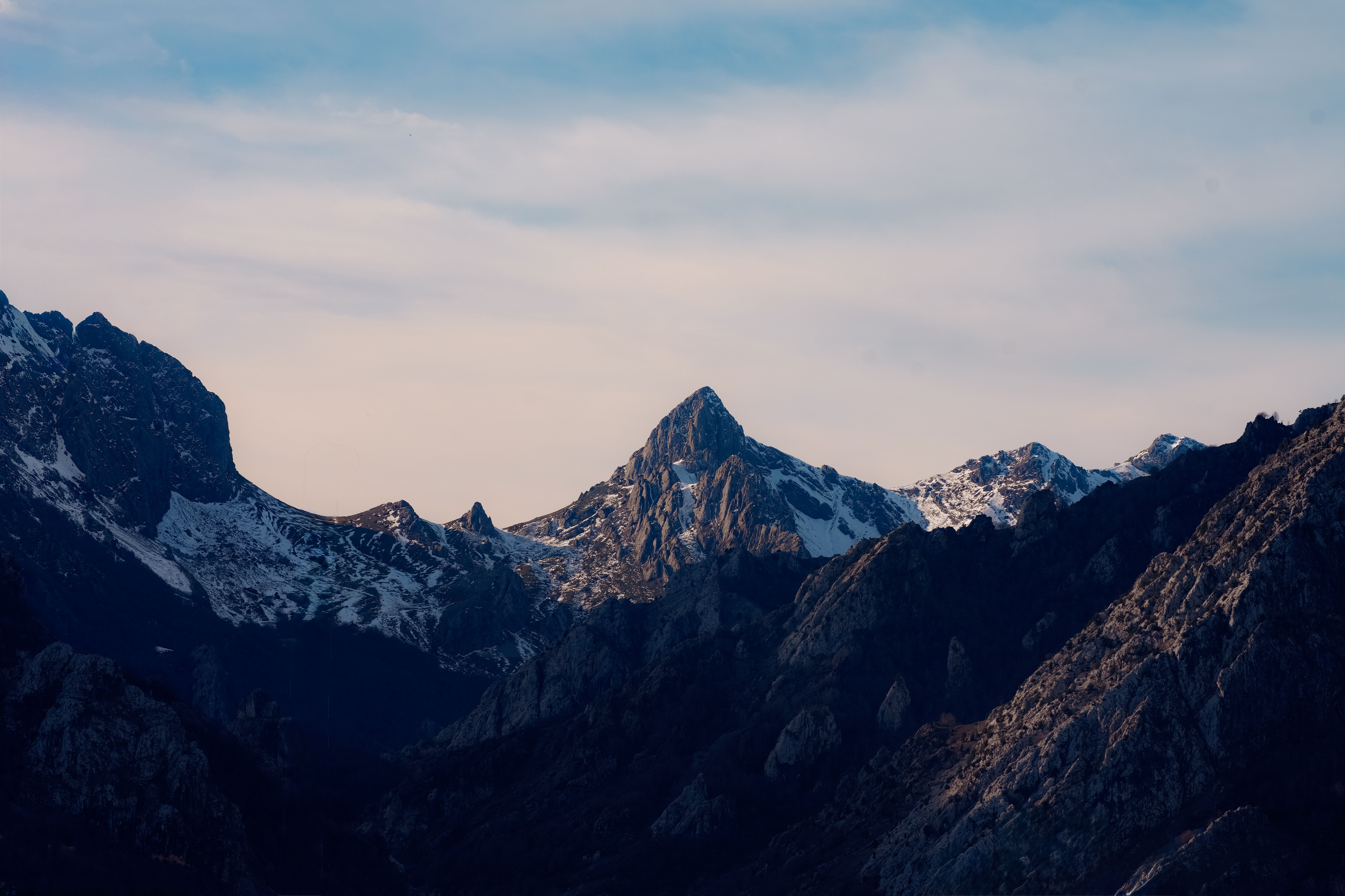 Dramatic limestone peaks of Picos de Europa National Park under a cloudy sky