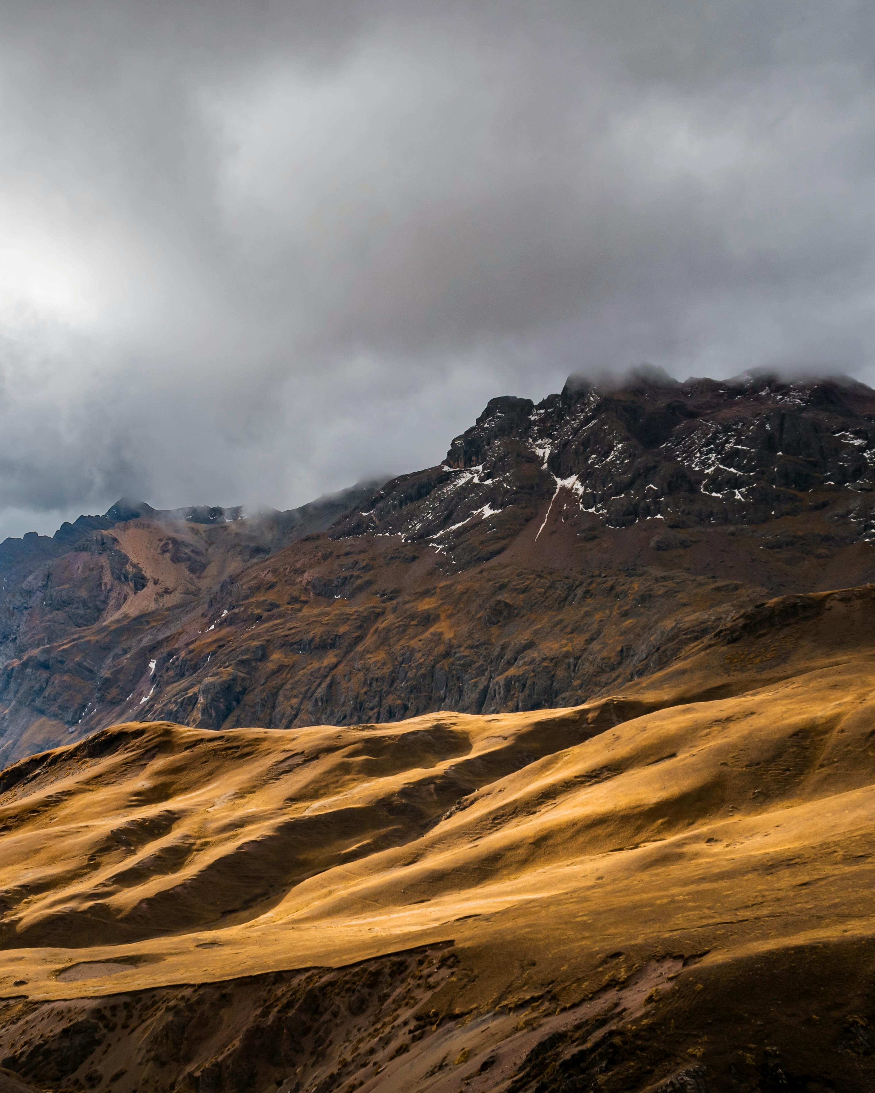 Stunning view of the Andes mountains under dramatic skies, highlighting Ausangate in Peru.