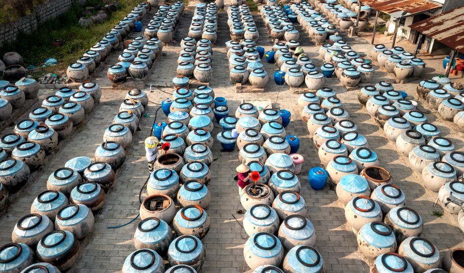 Aerial view of stone jars used for fermentation in a rural setting, Vietnam.
