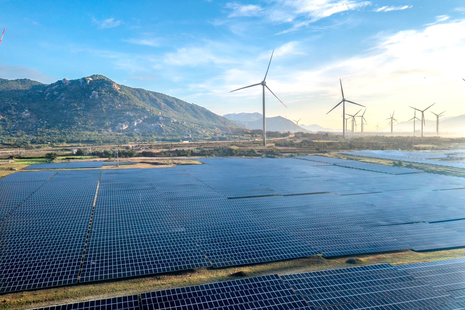 Solar panels and wind turbines representing renewable energy integration