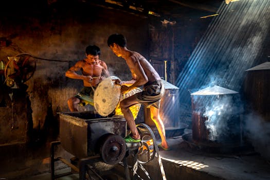Two men crafting traditional rice paper in a sunlit, rustic workshop.