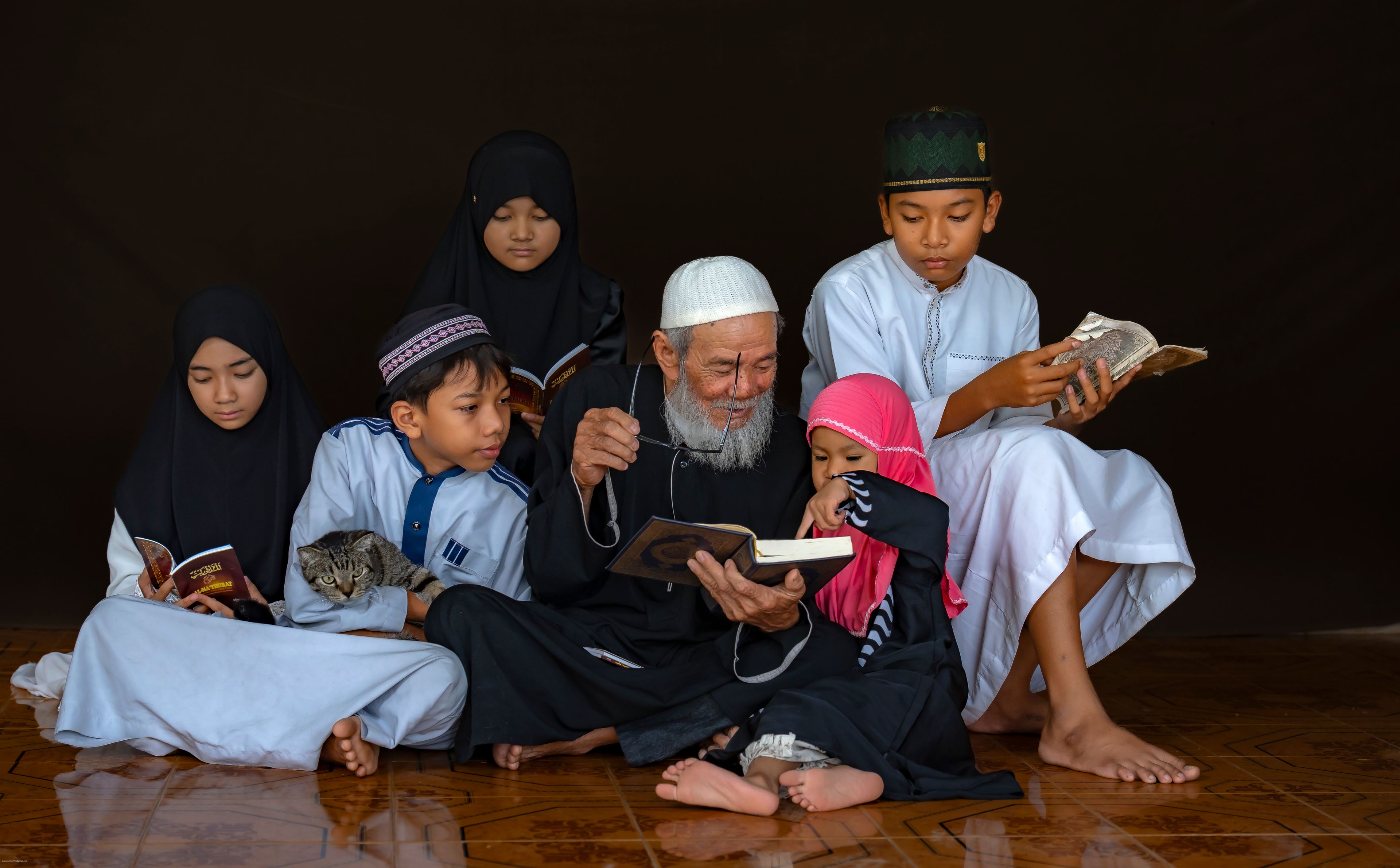 Three generations of a family reading together
