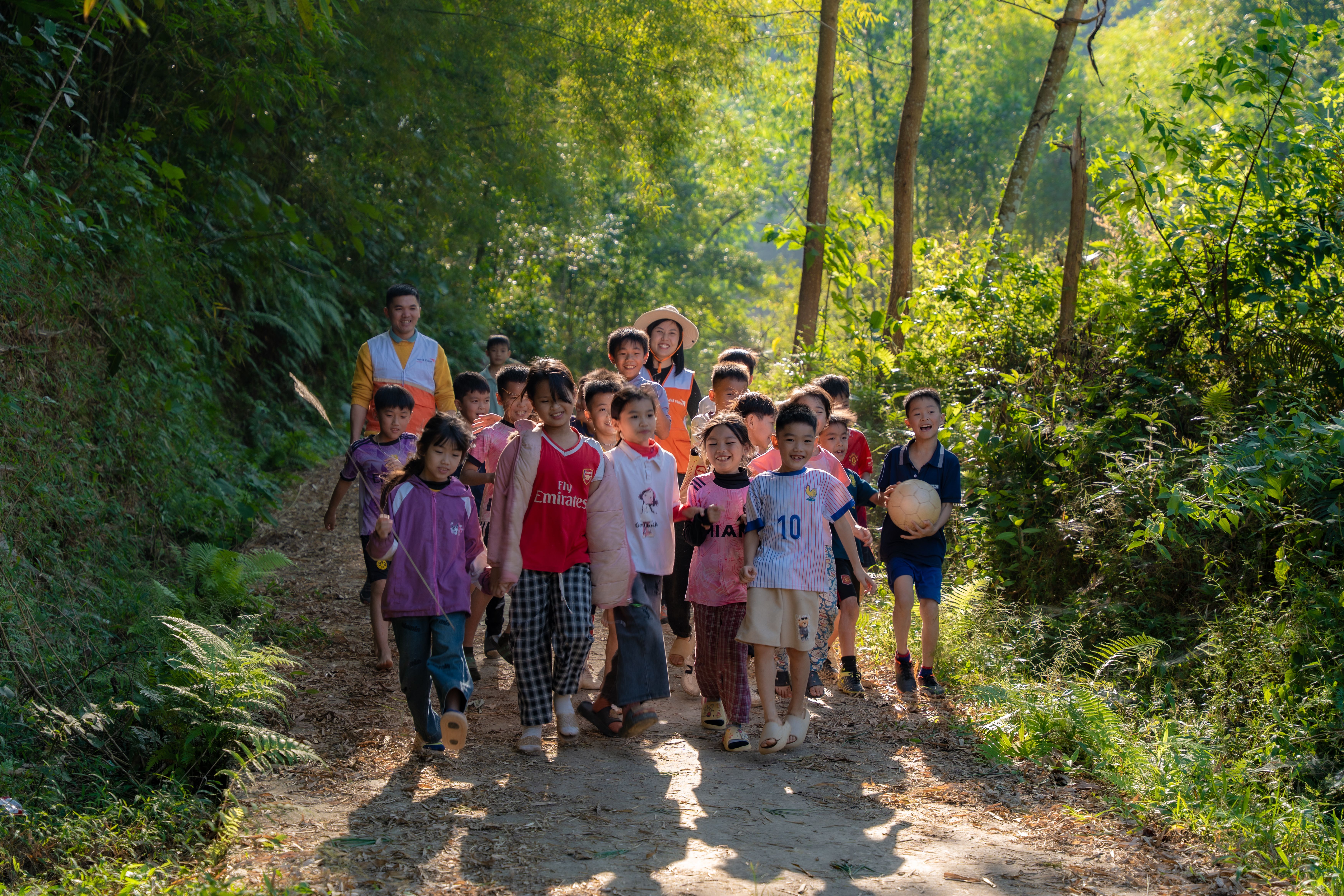 Group of students walking a forest path on an outdoor educational field trip