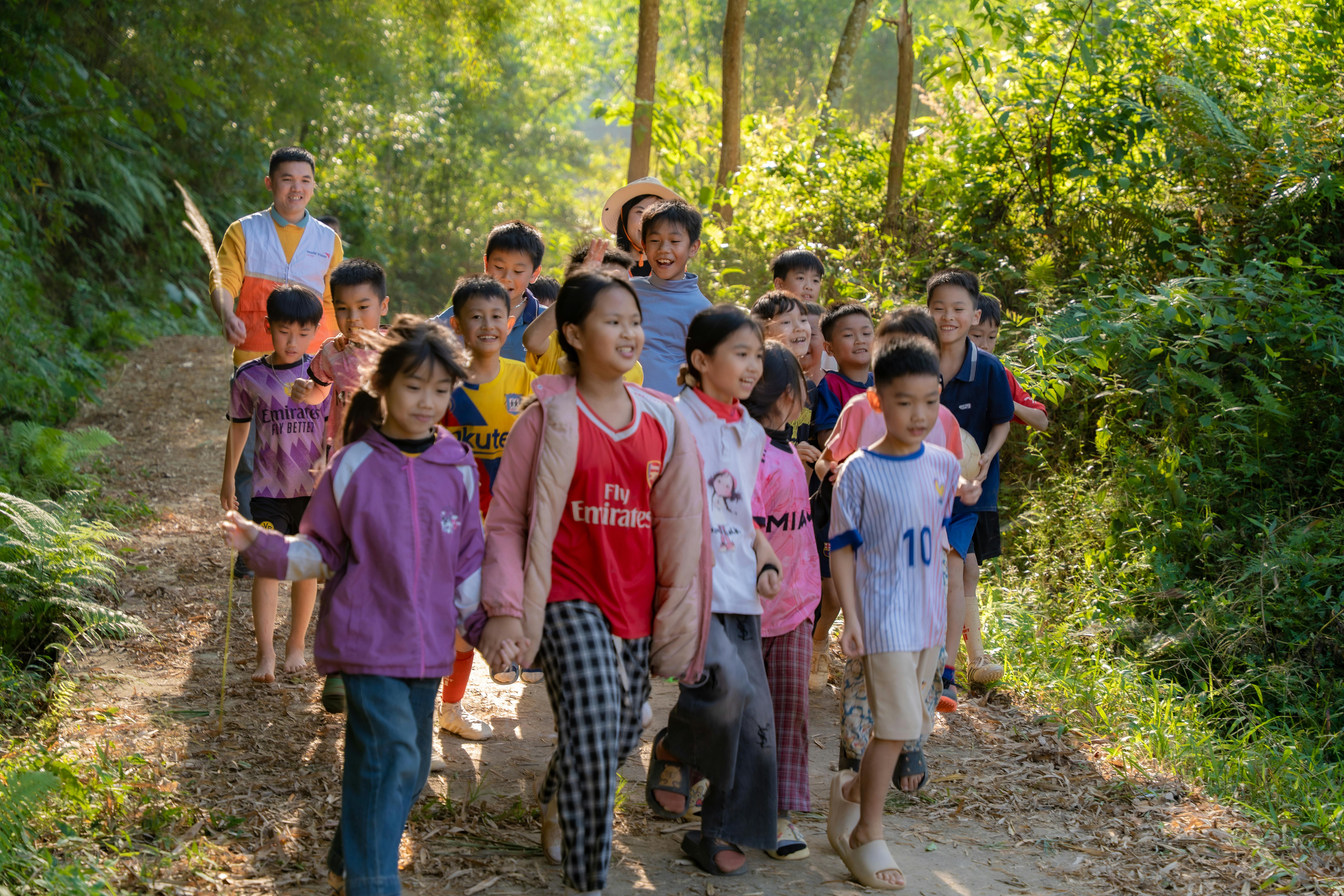 Group of Children Walking on Forest Path