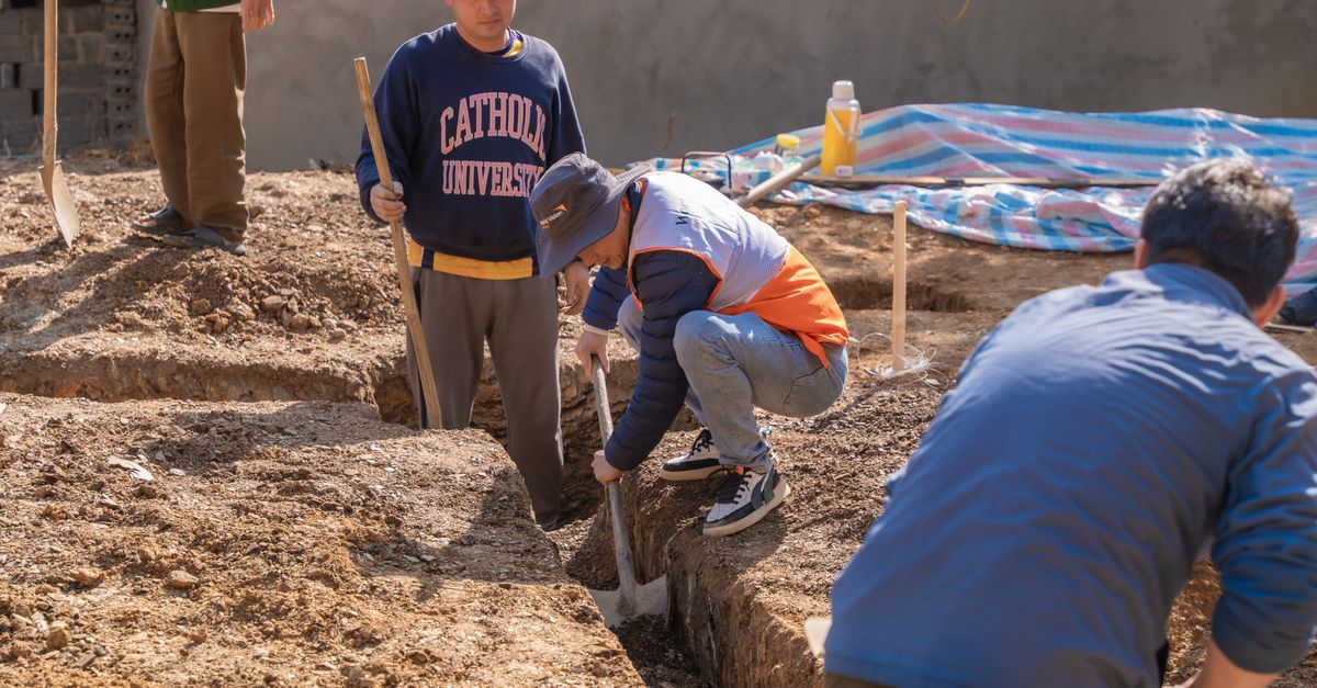Digging By Compress Construction Workers Digging Foundation Trench · Free Stock Photo