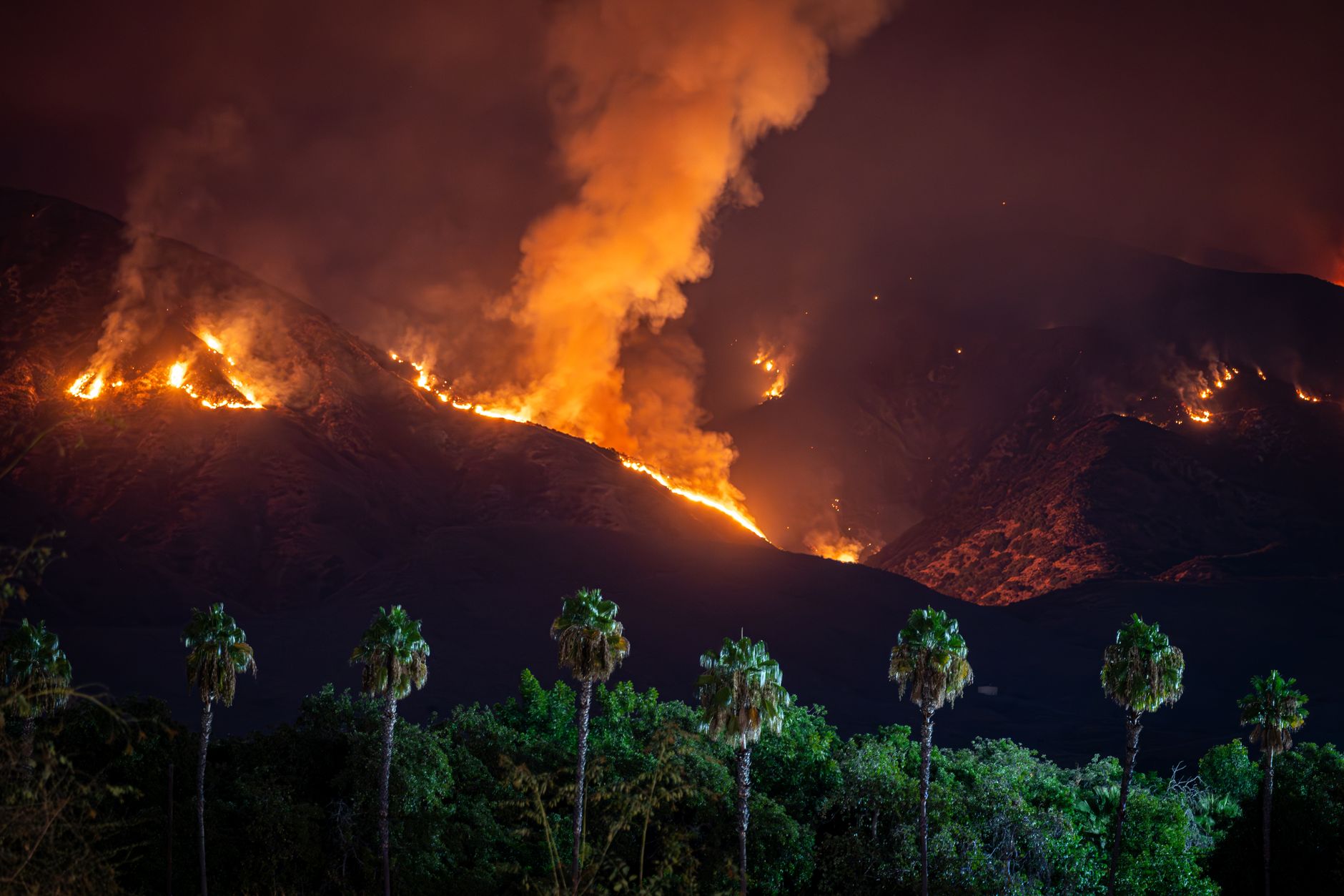 Active wildfire in California's forests releases fine particulate matter that travels thousands of miles and disrupts local precipitation patterns for extended periods.