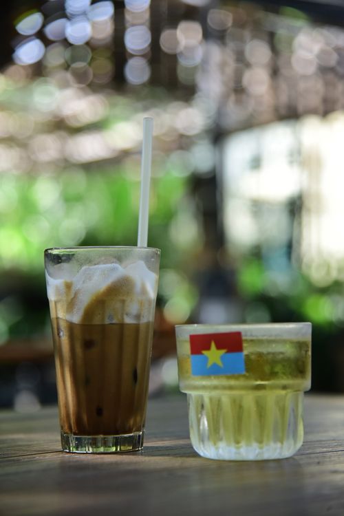 Free Iced coffee and herbal tea on a sunny day table outdoors with a bokeh background. Stock Photo