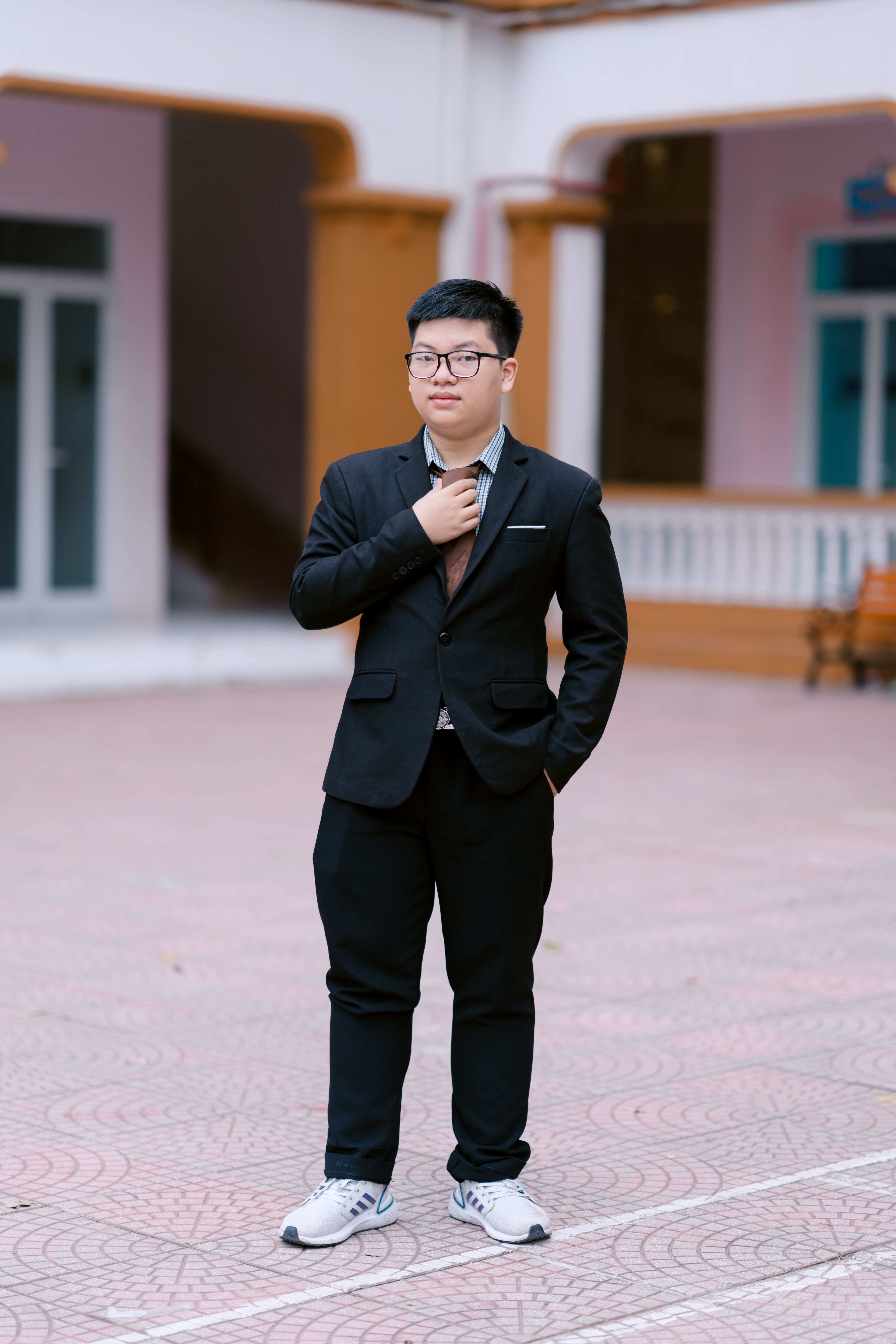 Young man in formal attire with sneakers outdoors · Free Stock Photo