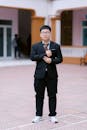 Young Man in Formal Suit in Courtyard
