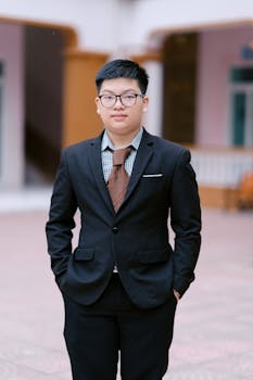 Confident young man in formal attire outdoors. Perfect for business or career-related themes.