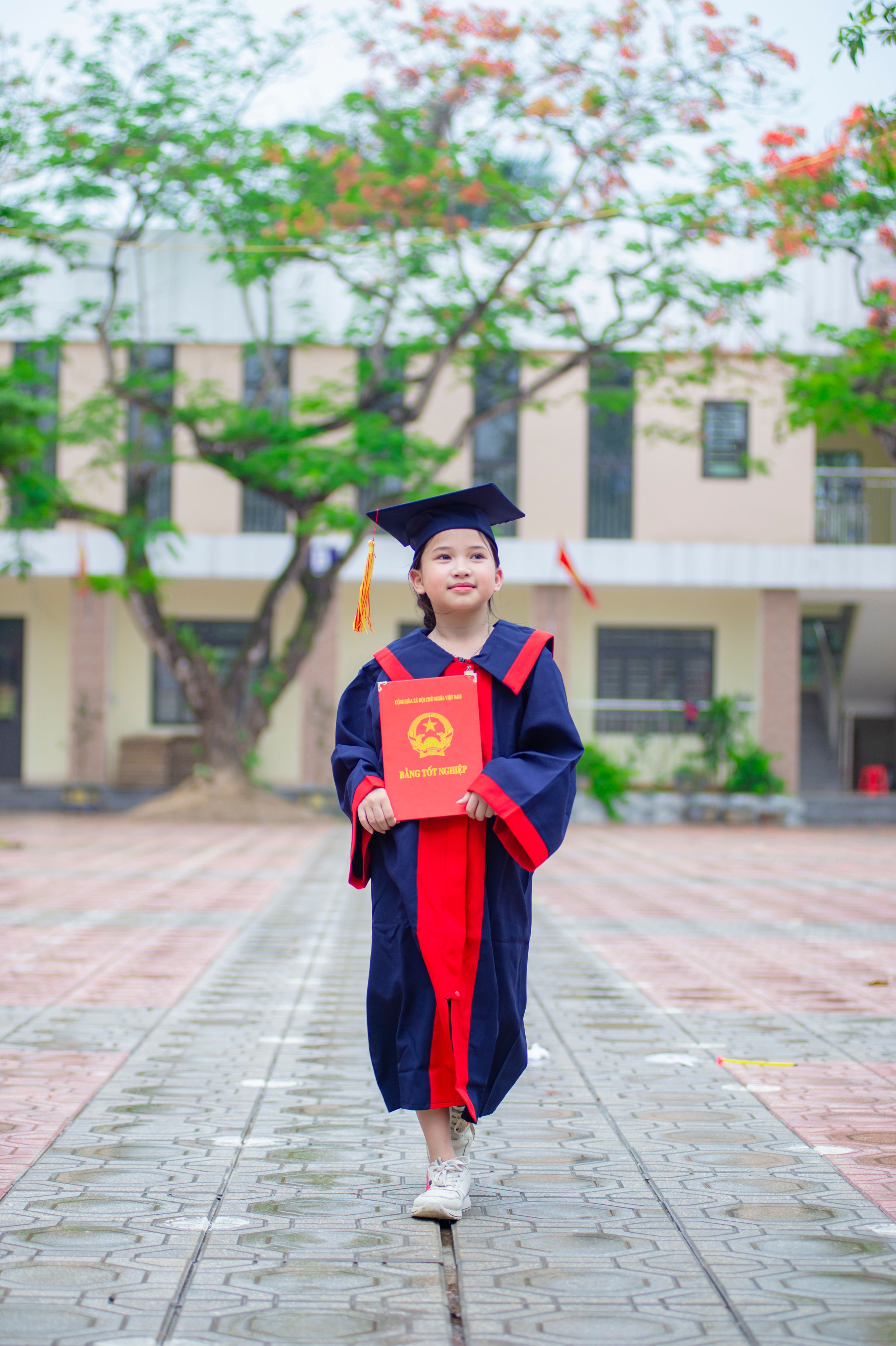 Young Graduate in Cap and Gown Outdoors · Free Stock Photo