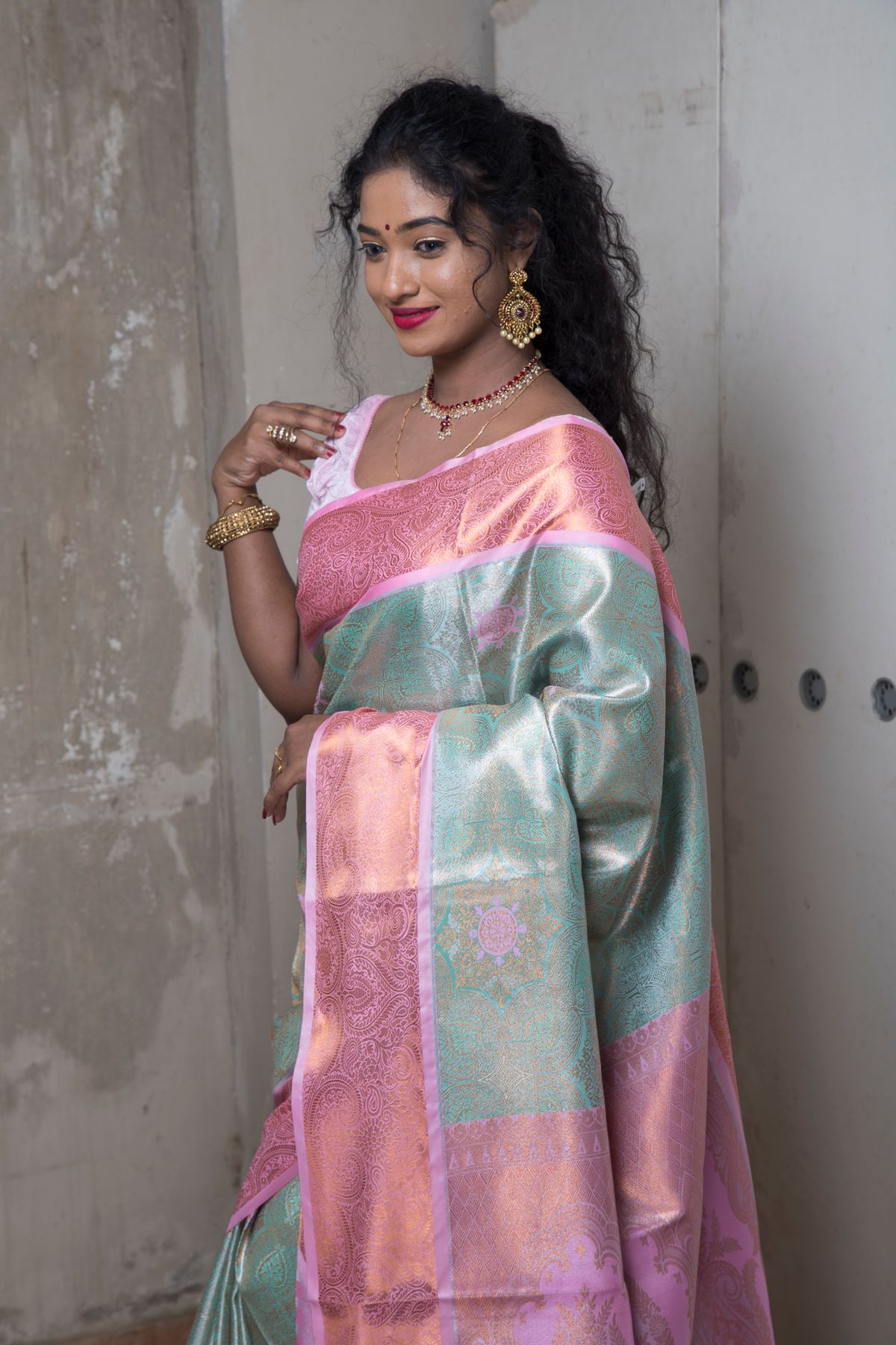 Model in a pastel pink and mint soft silk saree