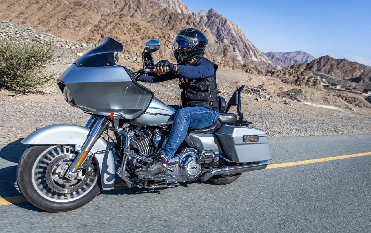 motorcyclist cruising a harley davidson through scenic dubai mountains