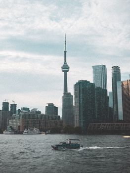 Stunning view of Toronto's skyline featuring the CN Tower, with boats navigating Lake Ontario.
