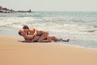 Man and Woman Kissing on Sea Shore