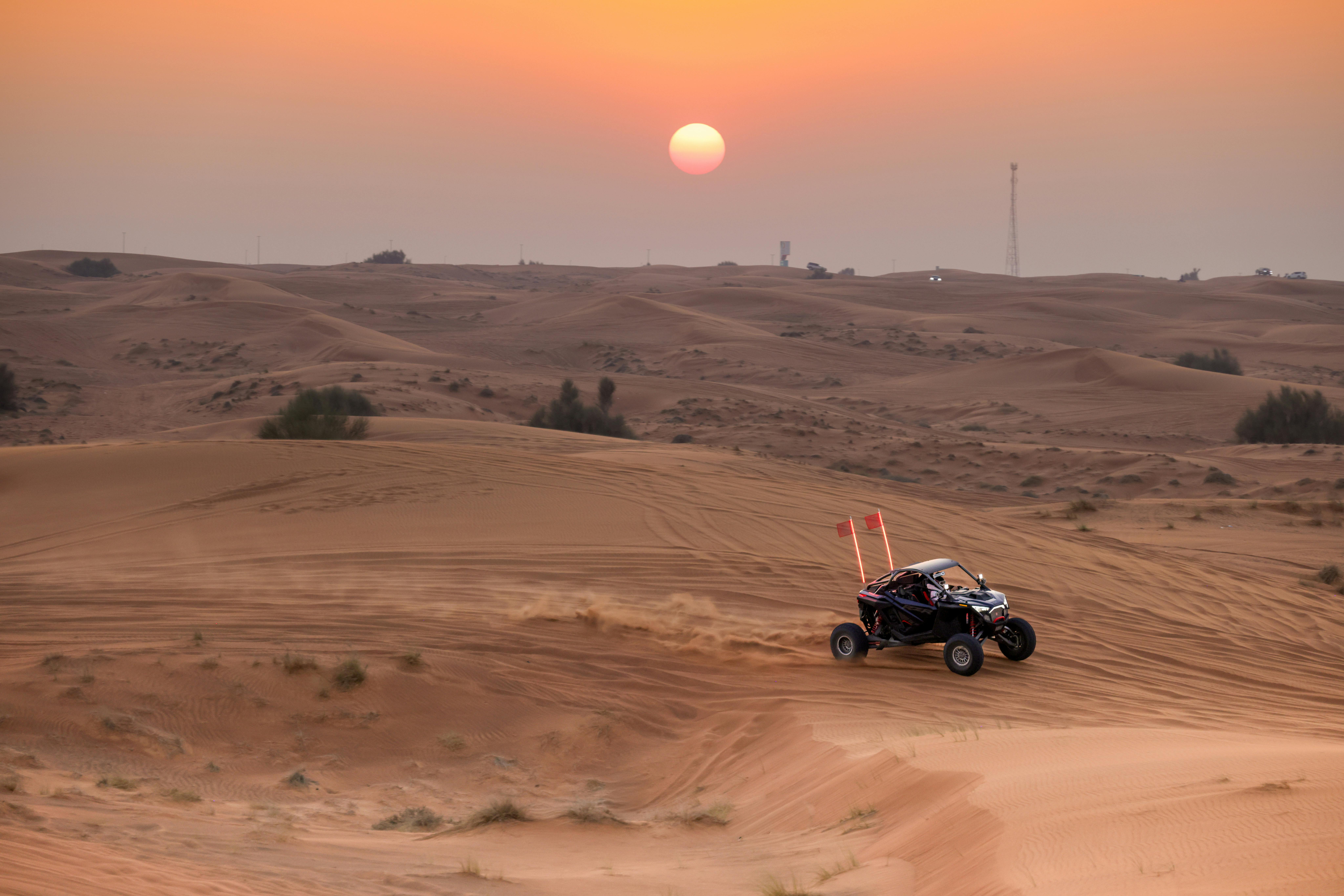 Experience the thrill of off-road adventure in the desert at sunset, capturing the vibrant hues and 