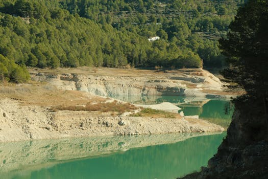 Beautiful view of Guadalest Reservoir with forests and reflections in Comunidad Valenciana, Spain.