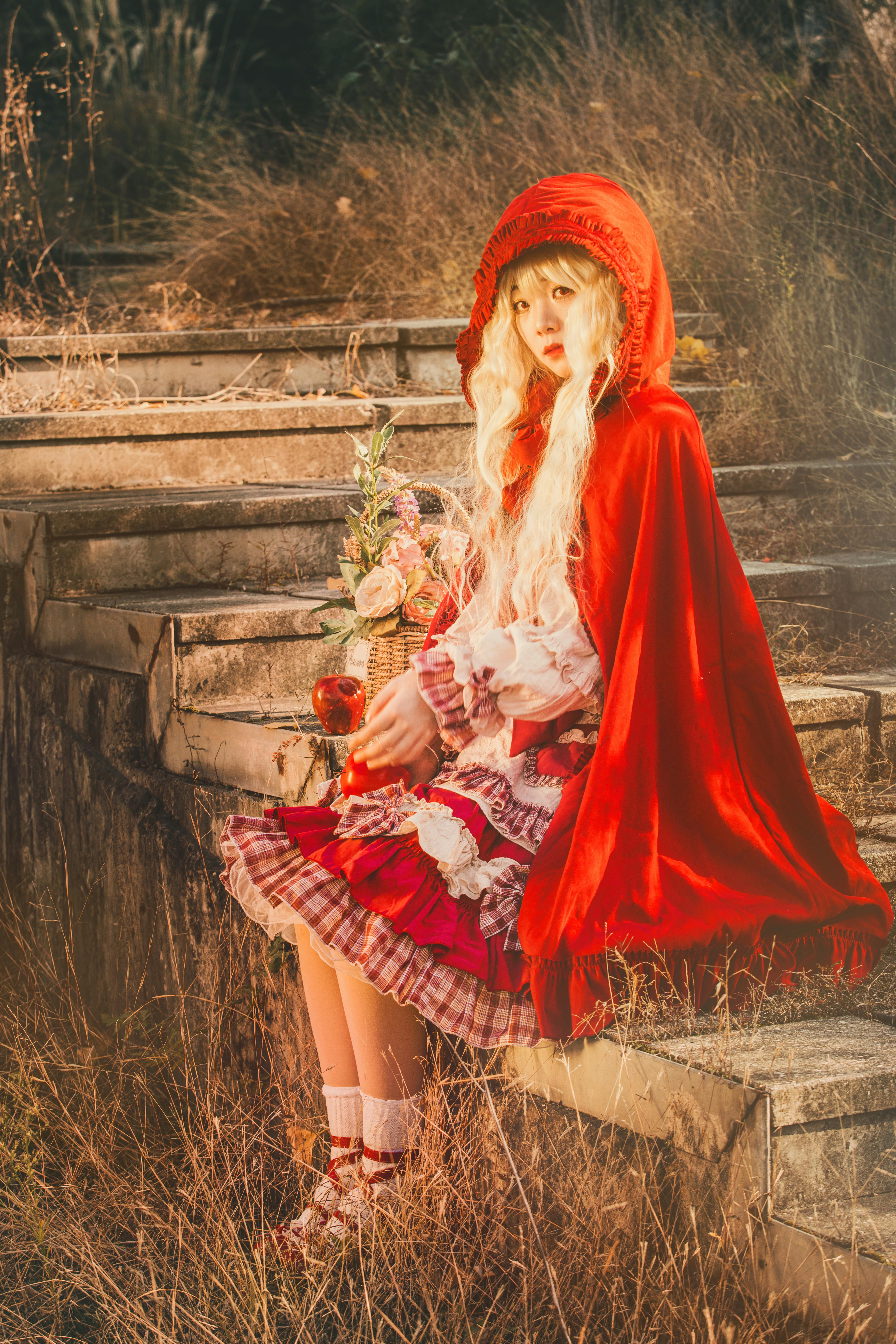Enchanting fairytale scene of a girl in a red cloak, evoking Little Red Riding Hood.