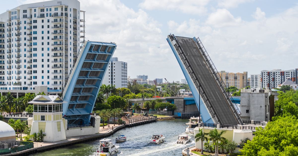 A beautiful view of a drawbridge raised in Miami, Florida, showcasing urban architecture and waterway traffic.
