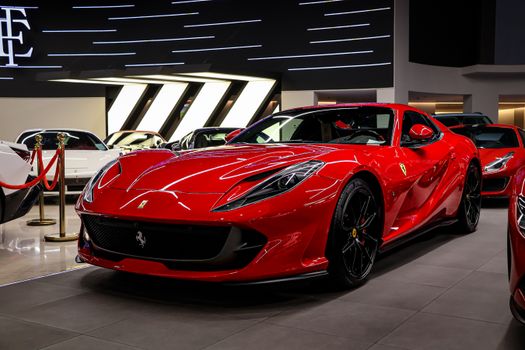 Eye-catching red sports car displayed in a contemporary auto showroom.