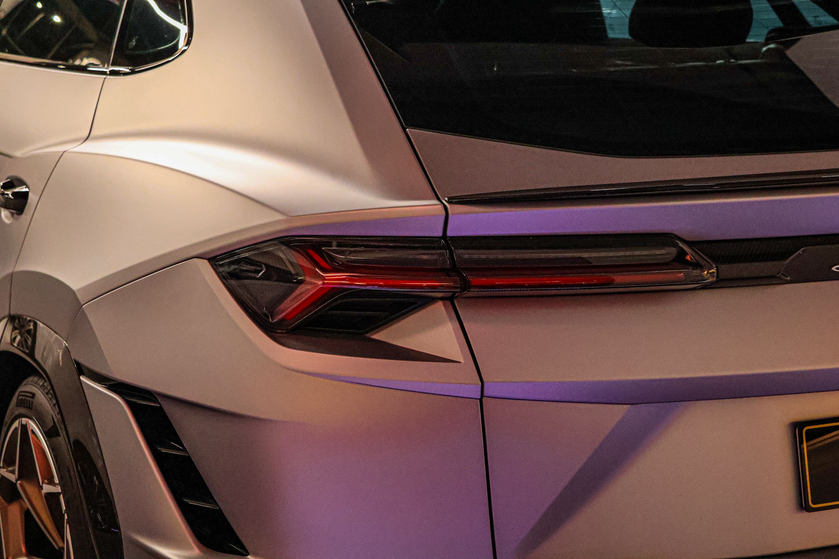 Sleek Luxury Car Rear Design in Showroom Setting · Free Stock Photo