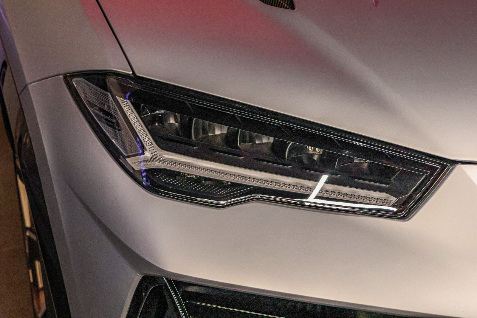 Close-up of a clear, restored headlight lens on a premium SUV after headlight restoration