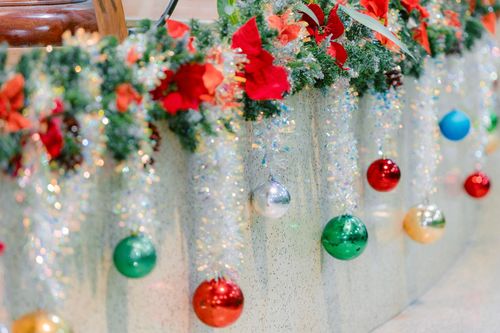 Free Vibrant Christmas ornaments and festive greenery create a holiday atmosphere. Stock Photo