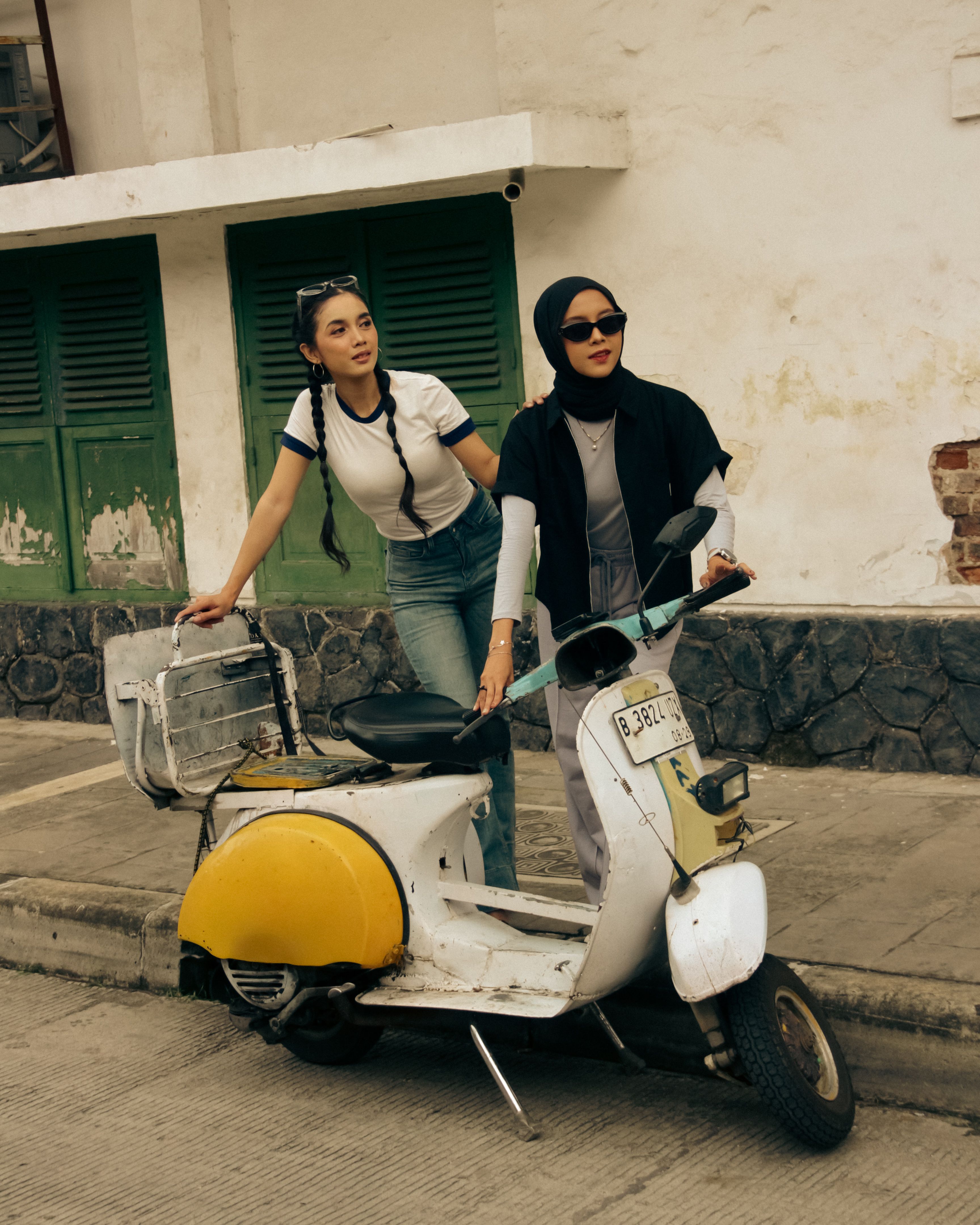 Two Women Posing with Vintage Scooter Outdoors