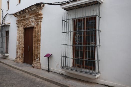 Side street view of a historic building facade in Puerto Real, Spain.