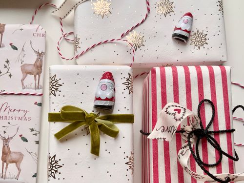 Free Beautifully wrapped Christmas gifts with festive decorations and ribbons. Stock Photo