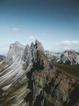 A dramatic aerial shot of the iconic Seceda mountain in the Dolomites, showcasing rugged peaks.