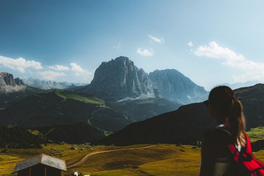 Scenic view of a hiker overlooking the Dolomites mountains, perfect for adventure and travel themes.