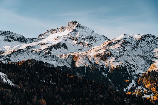 Breathtaking view of snowy mountains under a clear blue sky in a serene winter setting.