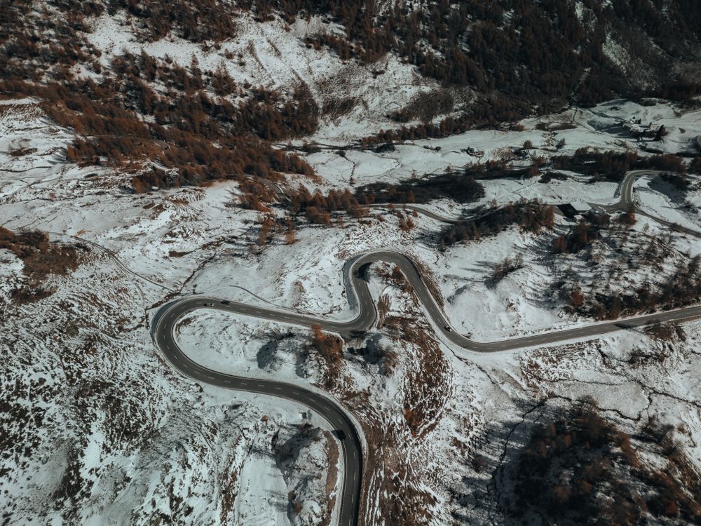 Aerial View of Winding Mountain Road in Snow · Free Stock Photo