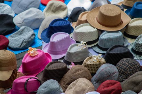Free A vibrant assortment of hats in various styles and colors on display outdoors. Stock Photo